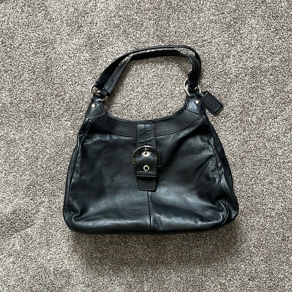 Coach purse.  Black. Three large pockets. Shoulder straps.
